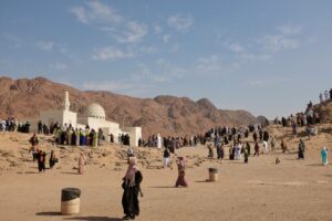 A large group of people standing in the desert