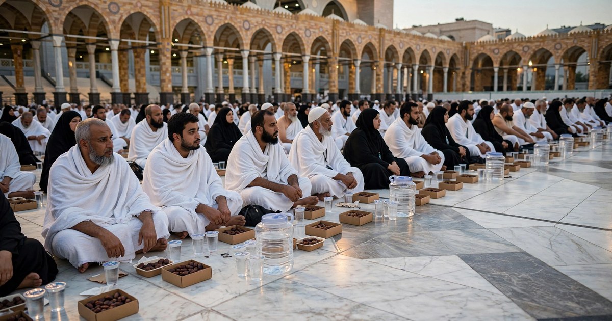 Pilgrims seated in rows for iftar on the marble courtyard of Masjid al-Haram during Ramadan