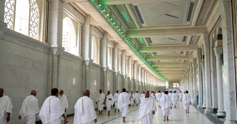 The Sa'i gallery between Safa and Marwa inside Masjid al-Haram, with pilgrims walking the marble corridor