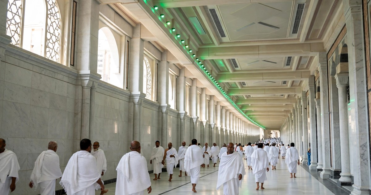 The Sa'i gallery between Safa and Marwa inside Masjid al-Haram, with pilgrims walking the marble corridor